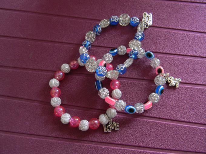 three beads in pink. blue and white acrylic beads with metal charm