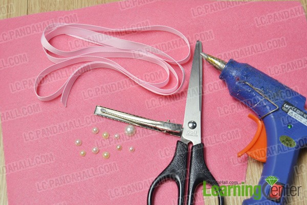 materials and tools for making a pink felt snowflake hair clip