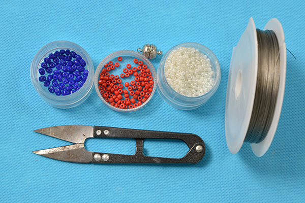 Supplies in making the red and blue woven seed bead bracelet: