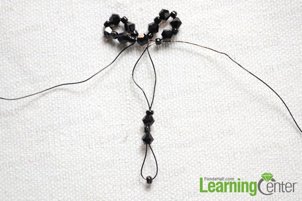 string 3 seed beads and 2 bicone beads onto the right wire