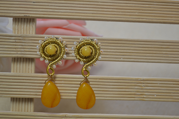 final look of the yellow gold dangling snail earrings