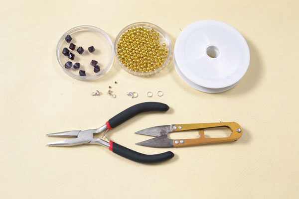 Supplies in making the purple glass bead flower bracelet: