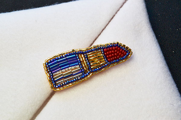 This, this lipstick felt brooch with seed and bugle beads has been finished: