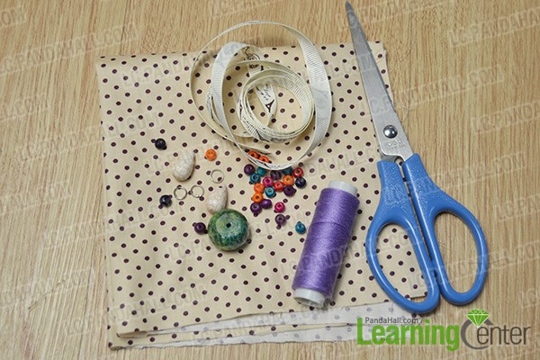 materials and tools for making a fabric flower bracelet with green stone