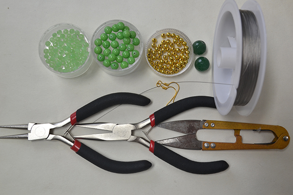 Materials and tools needed in the gold and green round drop earrings: