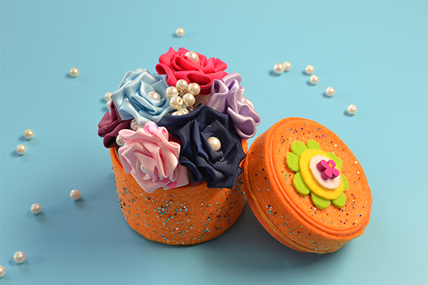 final look of the orange felt storage box with recycled box, felt, sequins and wood flower beads