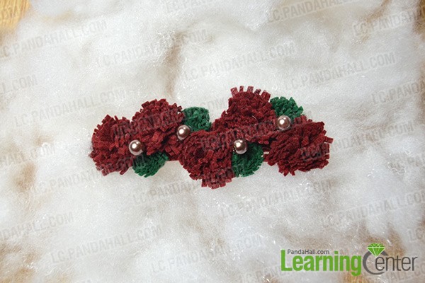 finished felt pom pom hair clip in red and green