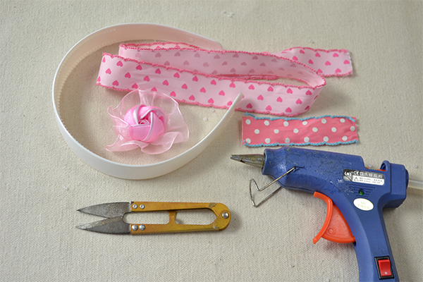 Supplies in making the ribbon flower headband in pink colors: