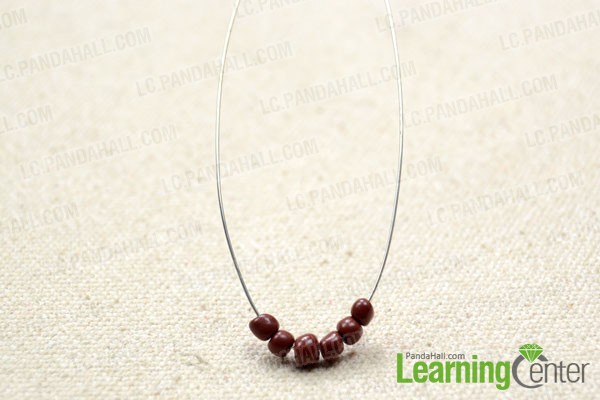 cut a length of 0.3mm copper wire and string 6 brown seed beads