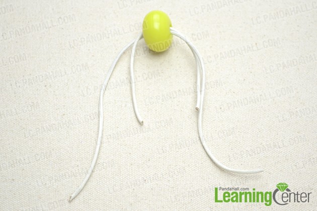 Pass two cords through the large acrylic bead