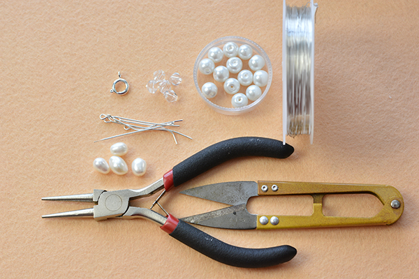 Supplies in making the simple and elegant wire wrapped pearl flower bracelet:
