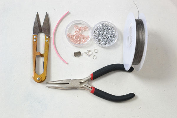 Supplies in making the pink leather bracelet with glass beaded ball ornaments: