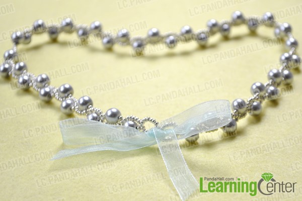 Finish DIY pearl necklace with ribbon tie