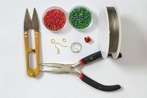 Supplies in making the red and green seed bead Christmas wreath earrings:
