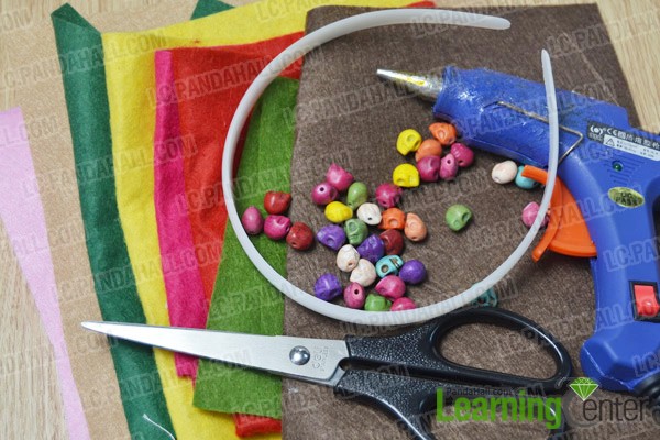 materials and tools for making a colorful heart headband for little girls