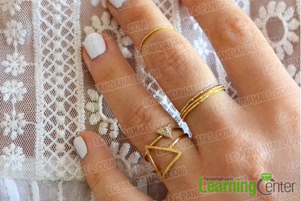 various knuckle rings on the fingers